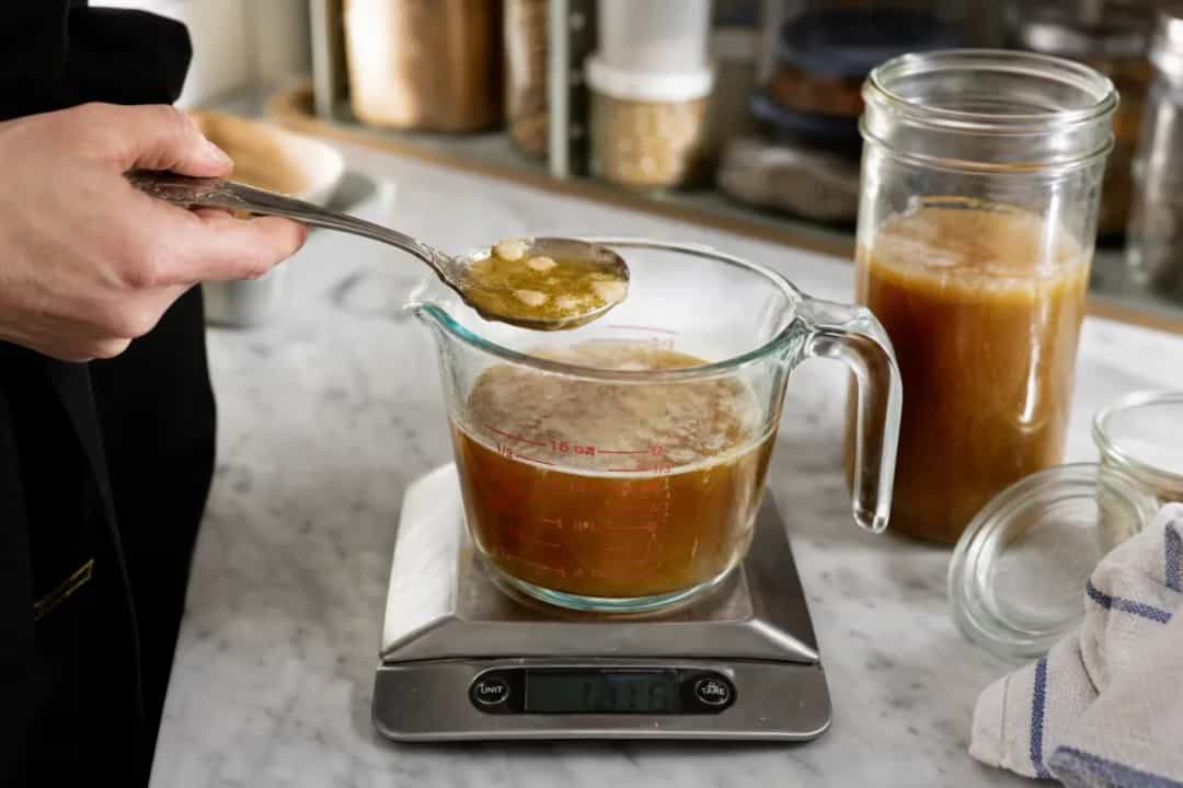 Editorial photo: Ice-Cube Degreasing: Skim Fat from Broths & Gravies (pro techniques tip) — realistic home-kitchen scene with visible tools and ingredients in n