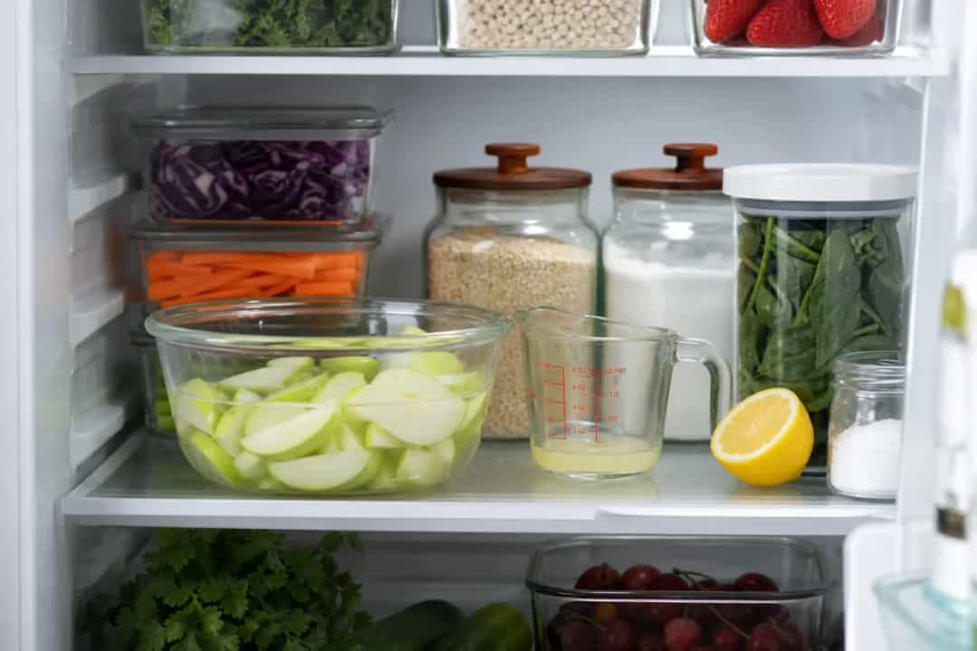 Editorial photo: How to Keep Cut Apples from Turning Brown (storage organization tip) — realistic home-kitchen scene with visible tools and ingredients in natur