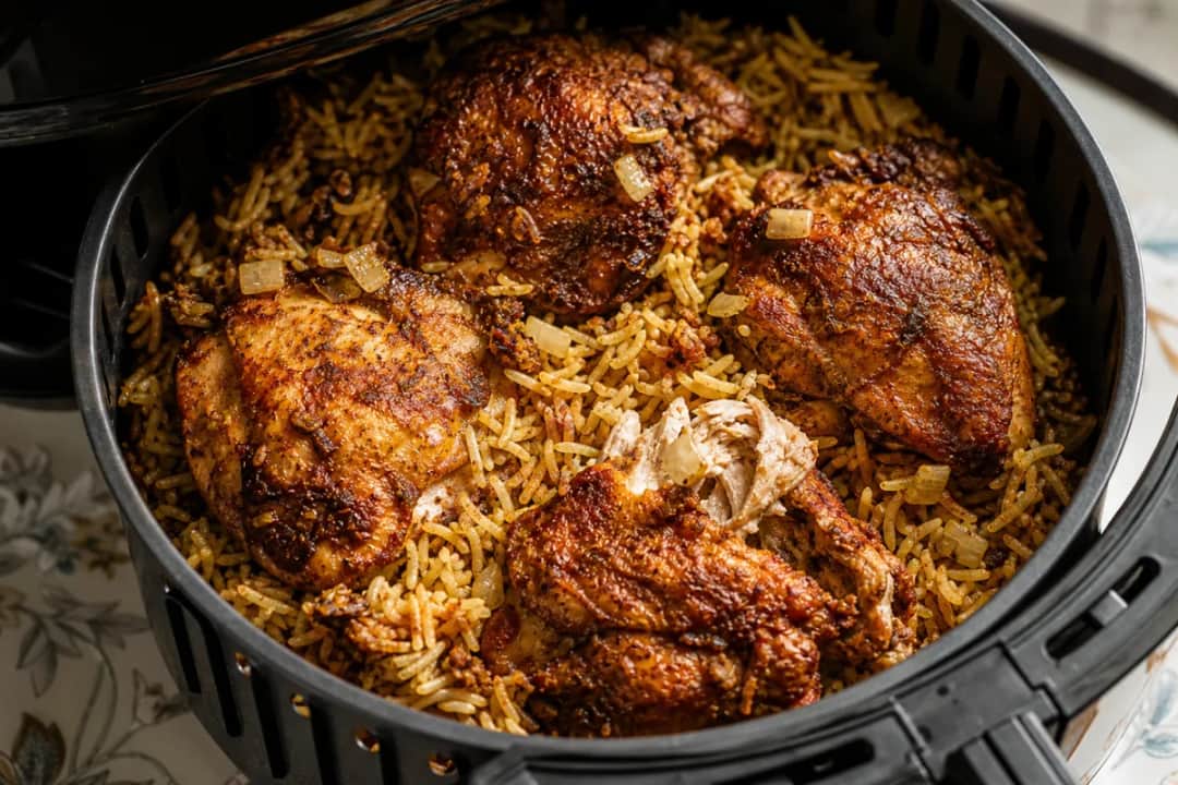 Plated Yemeni Chicken Mandi with spiced rice and roasted chicken on top.