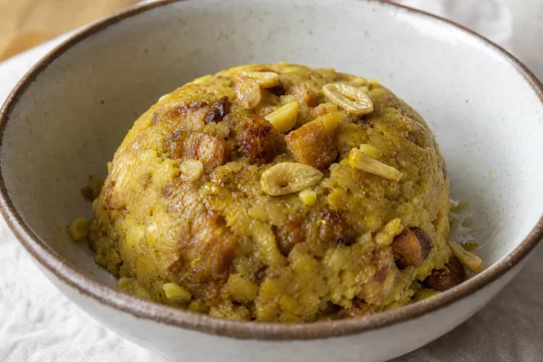 Mashed plantains mixed with garlic and chicharrón, garnished with parsley.