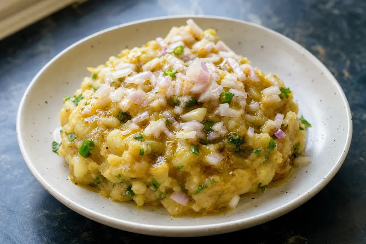 Smooth mashed potatoes mixed with mustard oil and green chilies, garnished with fresh coriander.