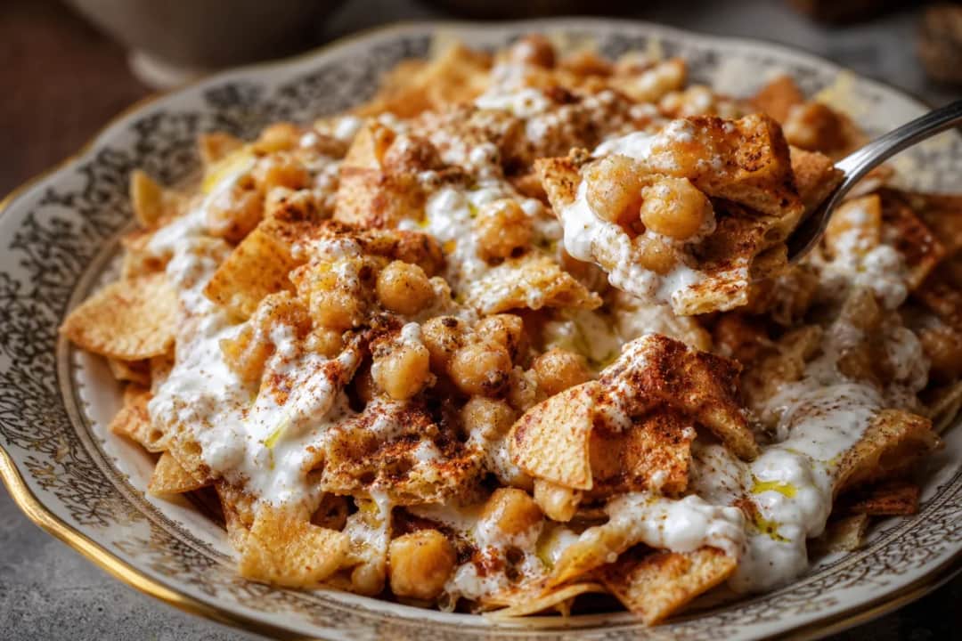 Crispy Syrian Fatteh topped with spiced chickpeas and creamy tahini yogurt sauce.