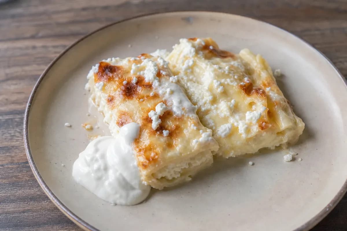 Layered pastry filled with creamy cheese, topped with sour cream and baked to golden perfection.