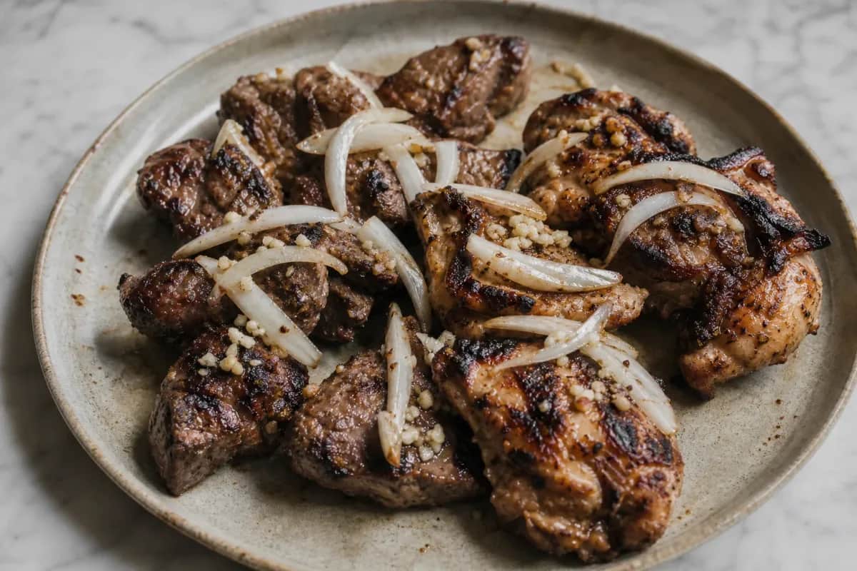 A vibrant plate of Jerusalem Mixed Grill featuring grilled meats, spices, and garnished with fresh herbs.