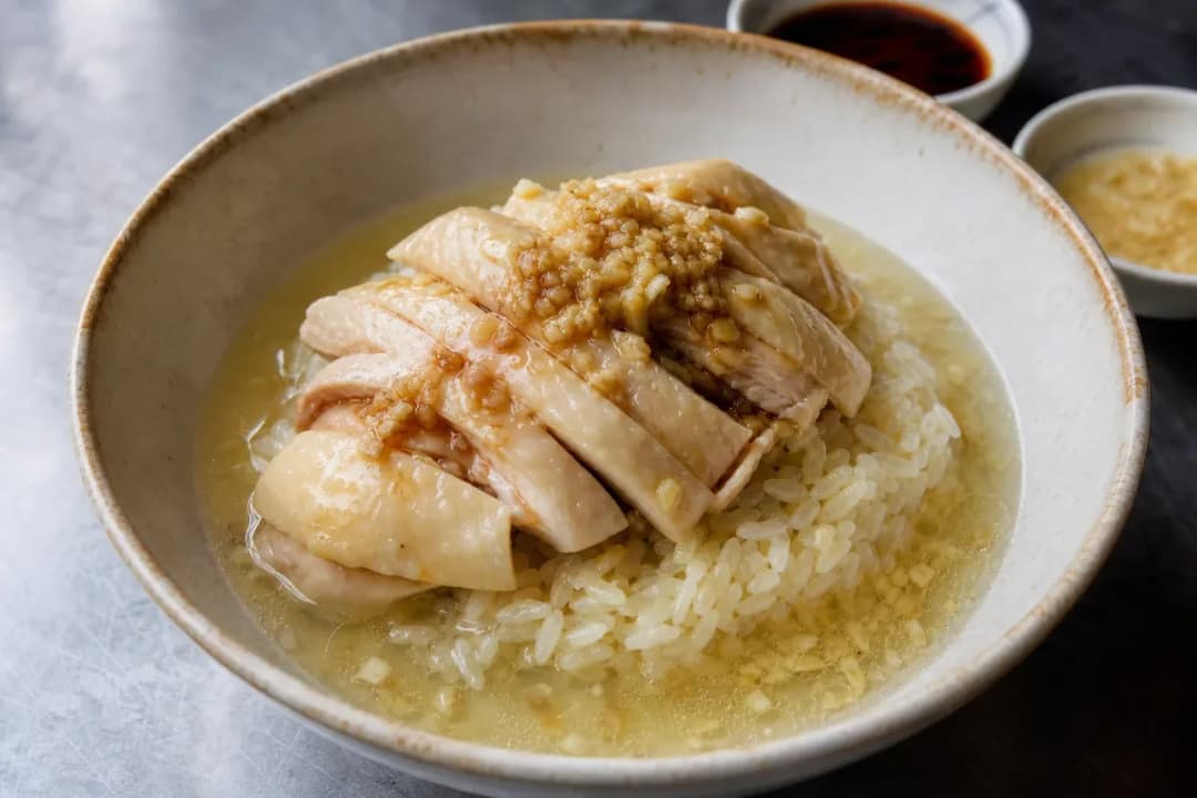 Close-up of Malaysian Hainanese Chicken Rice with Ginger and Chili Sauce, served in a bowl with clear ingredient detail (dinner recipe)