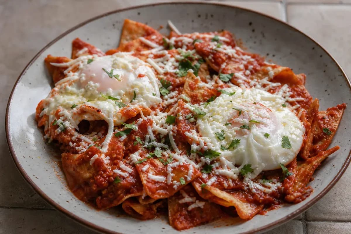 Mexican Chilaquiles Rojos with Eggs and Crema for Breakfast