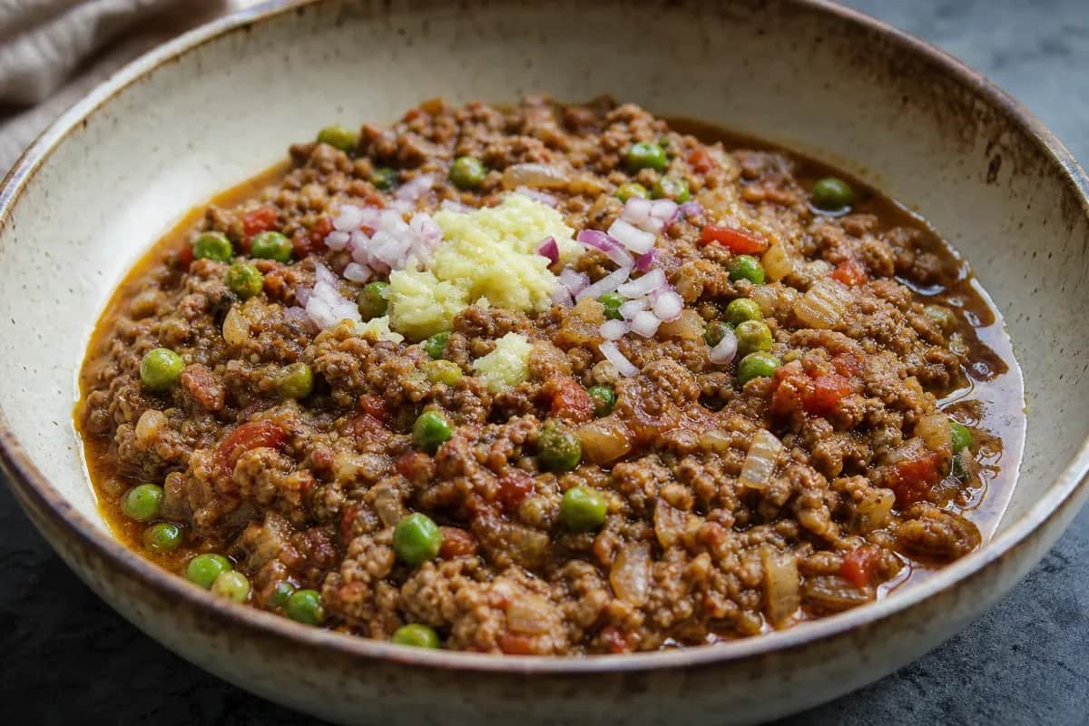 Aromatic Pakistani keema served with ground beef, peas, and spices garnished with fresh cilantro.