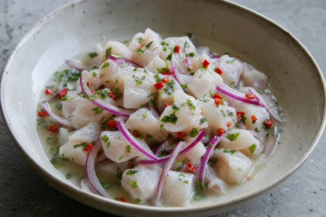 Close-up of Peruvian Ceviche with Lime, Red Onion and Fresh Chili, plated dish with natural food texture (dinner recipe)