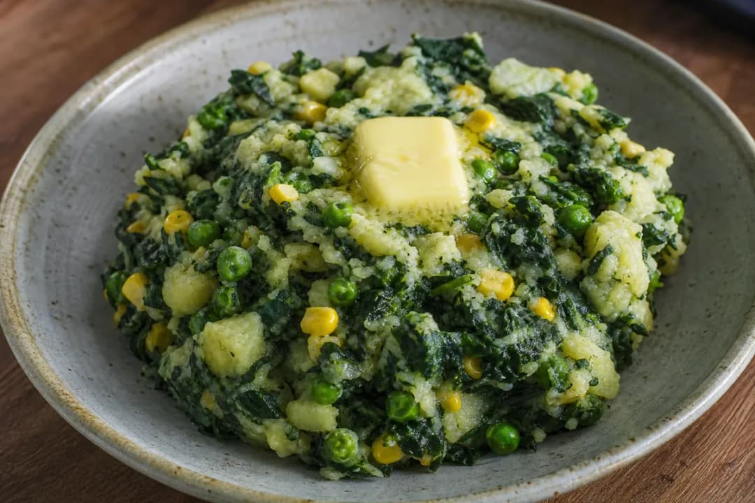 Close-up of Rustic Kenyan Mukimo with Potatoes, Greens, Corn and Peas, plated dish with natural food texture (vegetarian recipe)